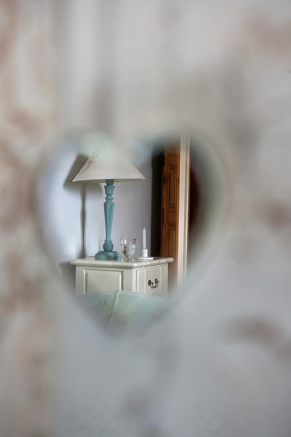 View Of Bedside Cabinet Through Heart-shaped Cut-out Photograph by Christophe Madamour