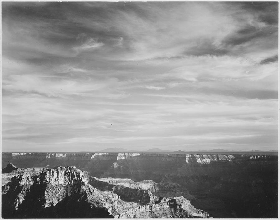 View of canyon in foreground horizon mountains and clouded sky from North Rim 1941  Grand Canyon National Park Arizona. 1941 Painting by Ansel Adams