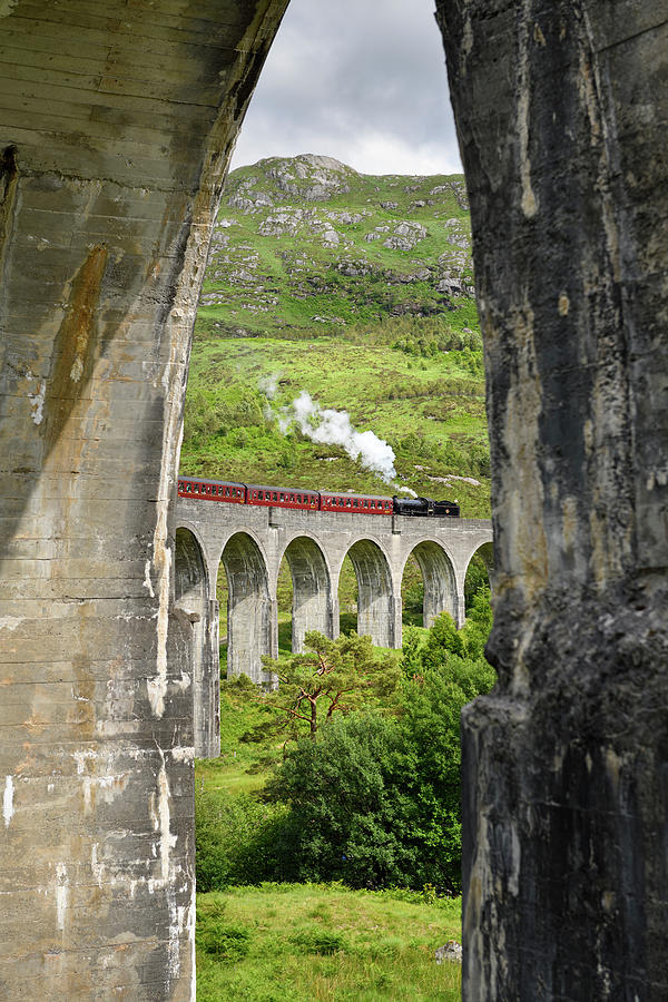 View of heritage Jacobite Steam Train through concrete columns o Photograph by Reimar Gaertner