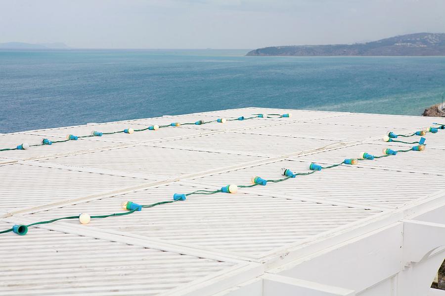 View Over The Roof Of A Beach House To The Sea Photograph by Guy Bouchet