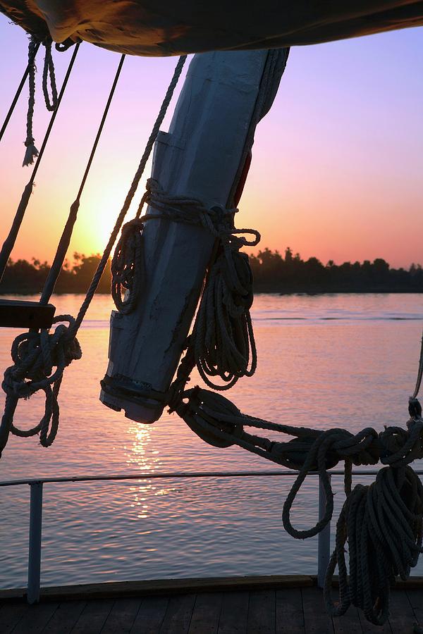 View Through A Sailboats Rigging Of A Red Sunset, Nile, Egypt Photograph by Guy Bouchet