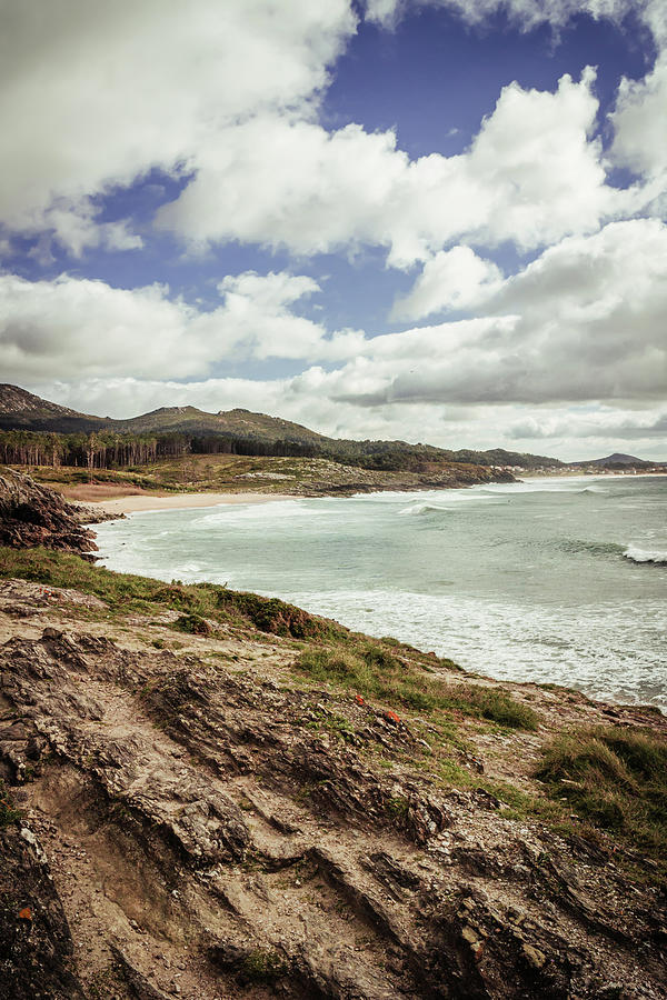 Views Of A Cliff With Beach And Mountains Under Blue Sky With Clouds ...