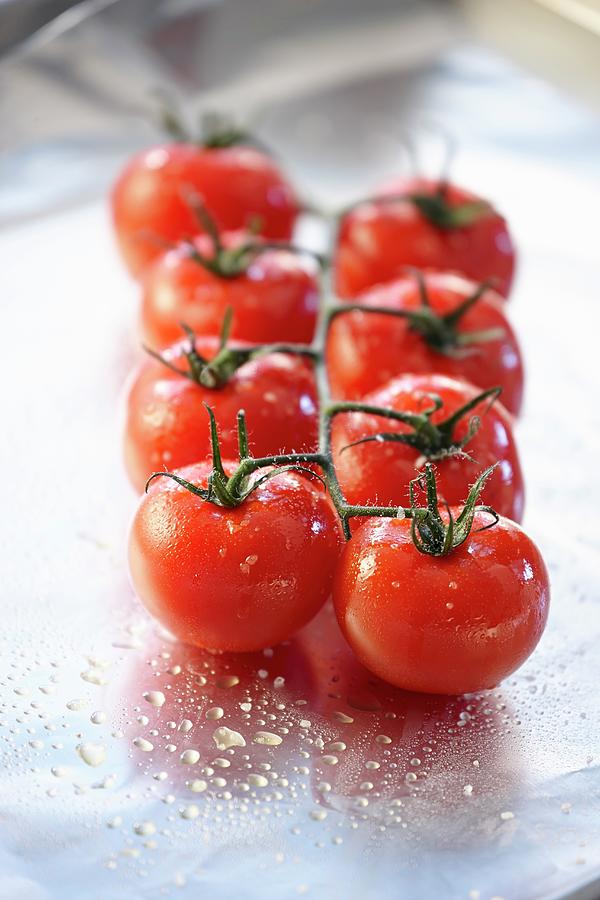 Vine Tomatoes Ready For Roasting In Aluminium Foil Photograph by