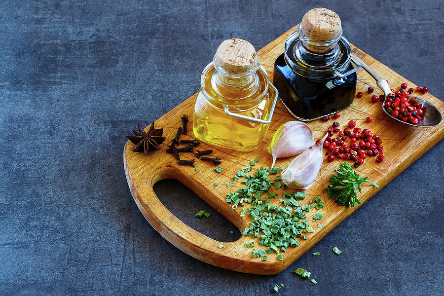 Vinegar, Oil, Herbs And Spices On A Vintage Wooden Board Photograph by Yuliya Gontar