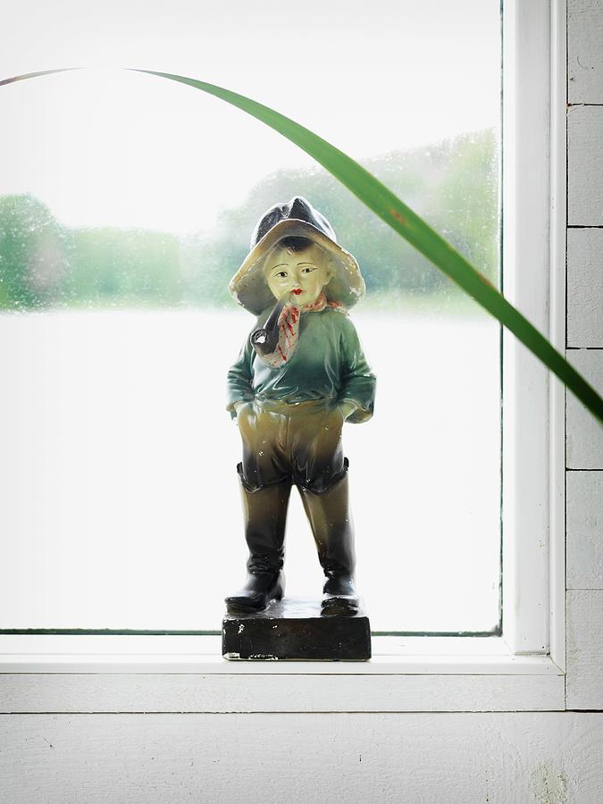 Vintage Angler Figurine In Front Of Misted Window Photograph by Peter Carlsson