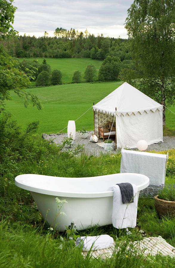Vintage Bathtub On Mountain Slope And View Of Tent-like Pavilion In Green Meadow Photograph by Annette Nordstrom