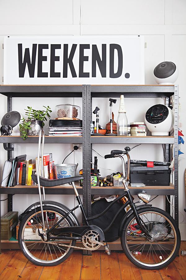 Vintage Bicycle In Front Of Metal Shelving And Large Sign Photograph by Natalie Jeffcott