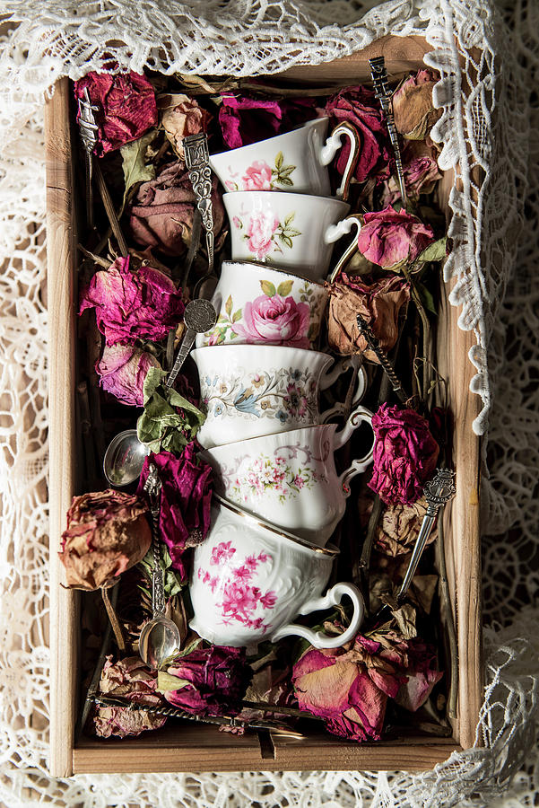 Vintage Cups With Floral Motifs And Dried Flowers Photograph by Ruud Pos