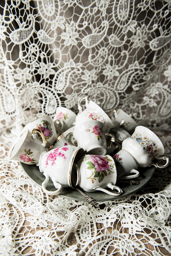 Vintage Cups With Floral Motifs On Plate Photograph by Ruud Pos