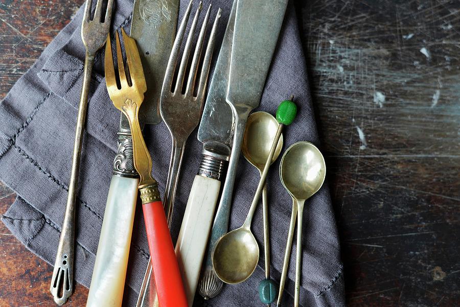 Vintage Knives And Forks On A Linen Napkin Photograph by Holly Pickering