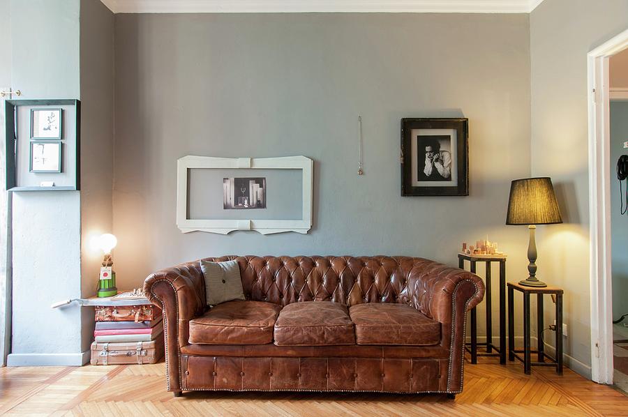 Vintage Leather Sofa Below Picture Frames On Grey-painted Wall And Table Lamps On Small Side Tables Photograph by Andrea Cuscuna