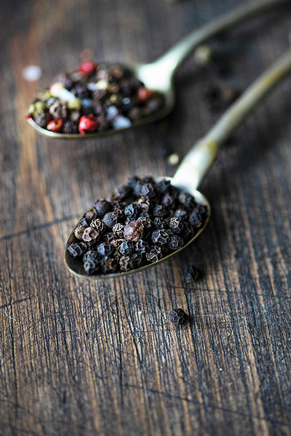 Vintage Spoons Full Of Different Types Of Peppercorn Spice On A Board Photograph by Anna Bogush