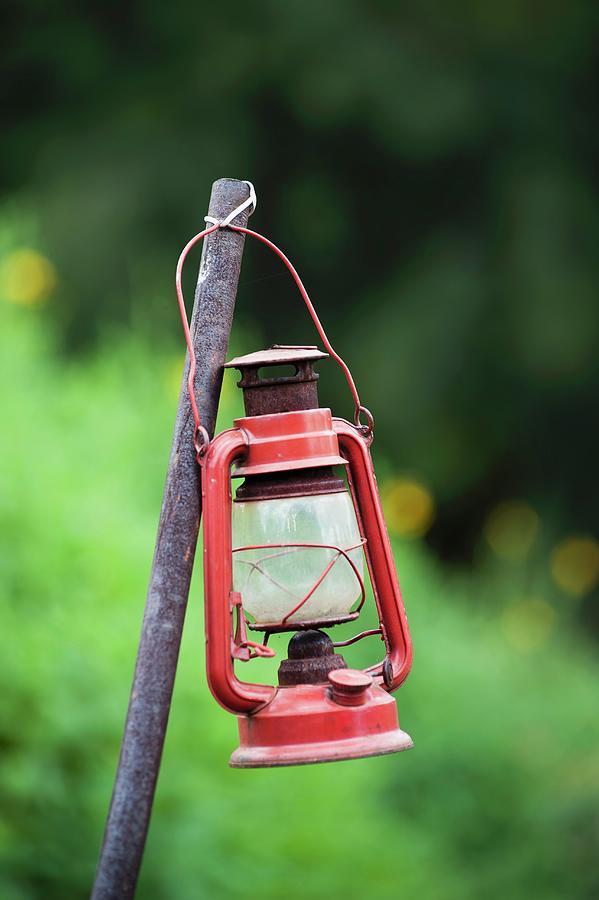 Vintage Storm Lamp Attached To Metal Rod In Garden Photograph by Great Stock!