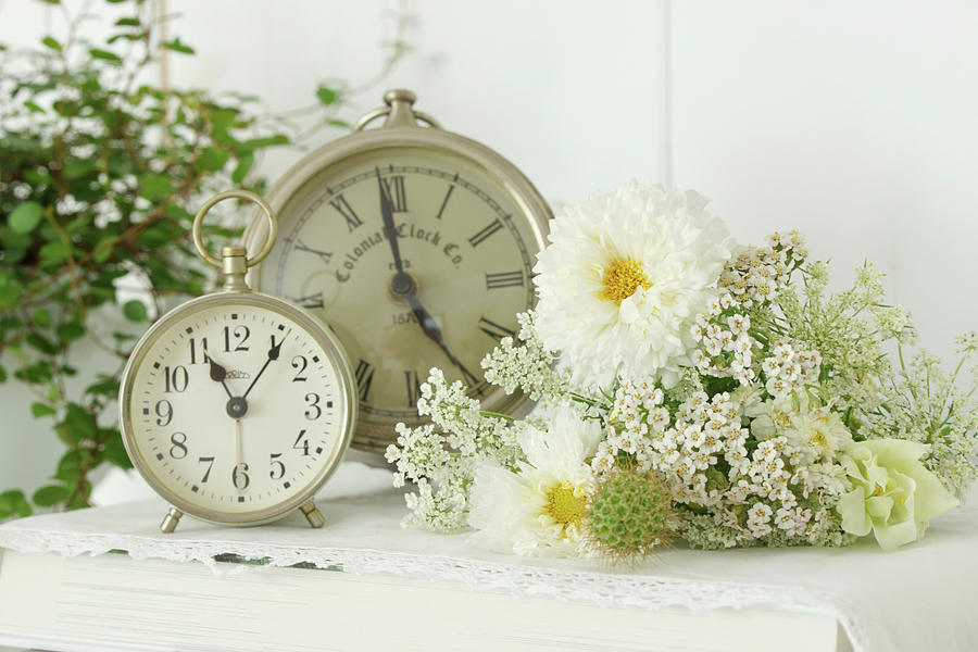 Vintage-style Arrangement Of Cosmea, Queen Annes Lace, Yarrow And Snapdragons Next To Two Clocks Photograph by Angelica Linnhoff