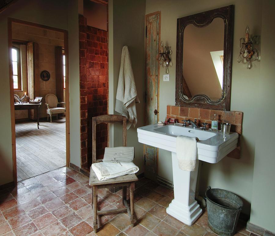 Vintage-style Bathroom With Old Terracotta Tiles And Crystal Sconce Lamps Above French Pedestal Washbasin Photograph by Christophe Madamour