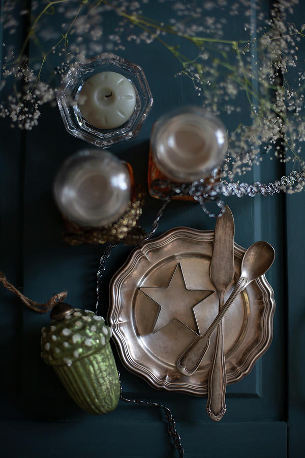 Vintage-style Winter Arrangement With Silver Plate On Blue Surface Photograph by Alicja Koll