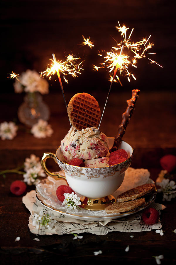 Vintage Tea Cup Filled With Raspberry Ripple Ice Cream And Topped With Stroopwafel Cookies And Sparklers Photograph by Jane Saunders