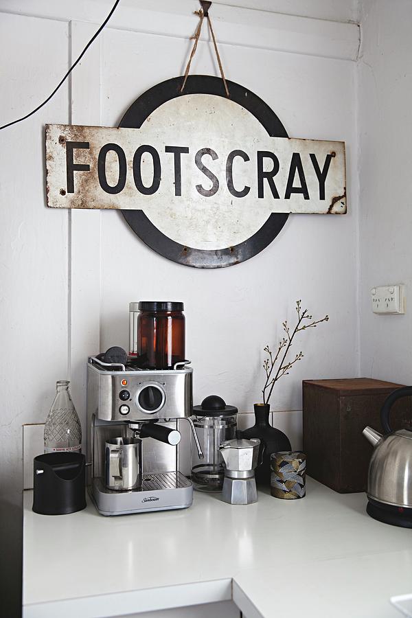 Vintage Train Station Sign Above Various Coffee Machines On Kitchen Counter Photograph by Natalie Jeffcott