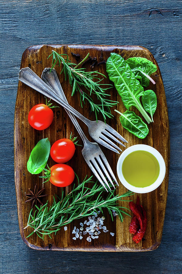 Vintage Wooden Chopping Cutting Board And Fresh Ingredients For Healthy Cooking On Dark Rustic Background Photograph by Yuliya Gontar