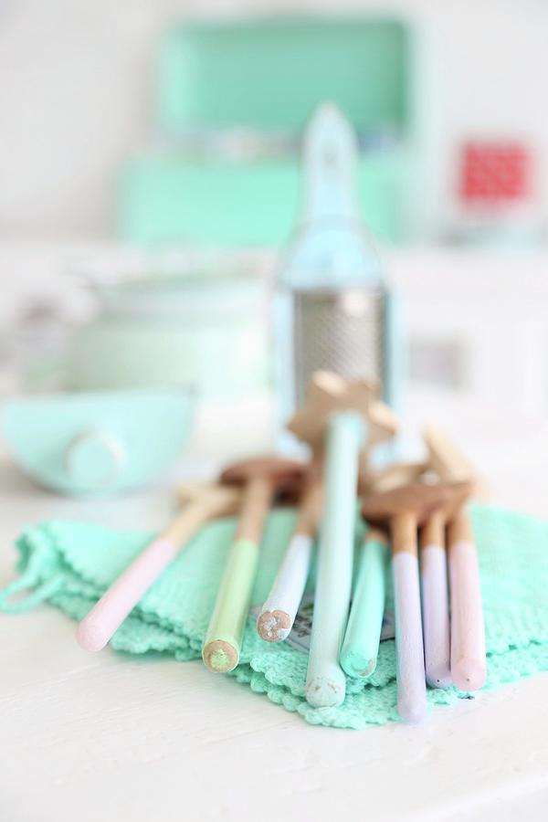Vintage Wooden Spoons In Pastel Shades On Turquoise, Lacy Doily Photograph by Syl Loves