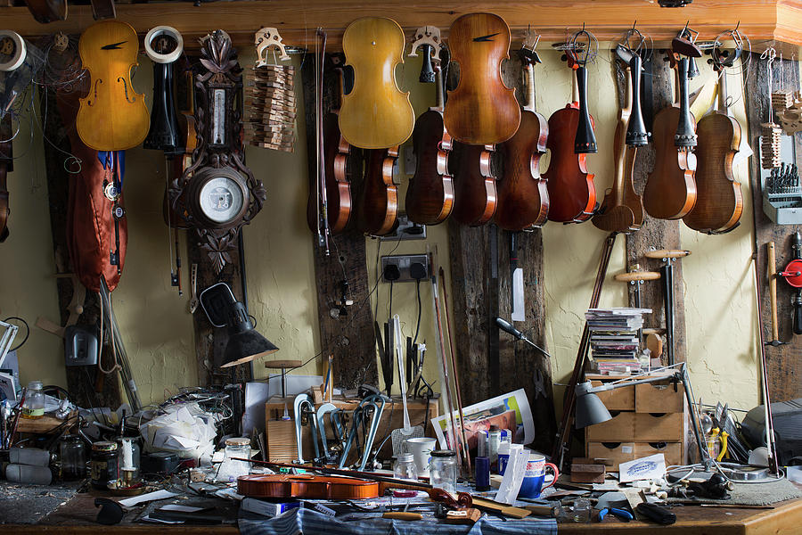 Violins Hanging In Workshop Photograph by Gary John Norman