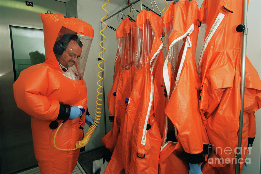 Virologist Putting On A Protective Suit Photograph by Philippe Psaila ...