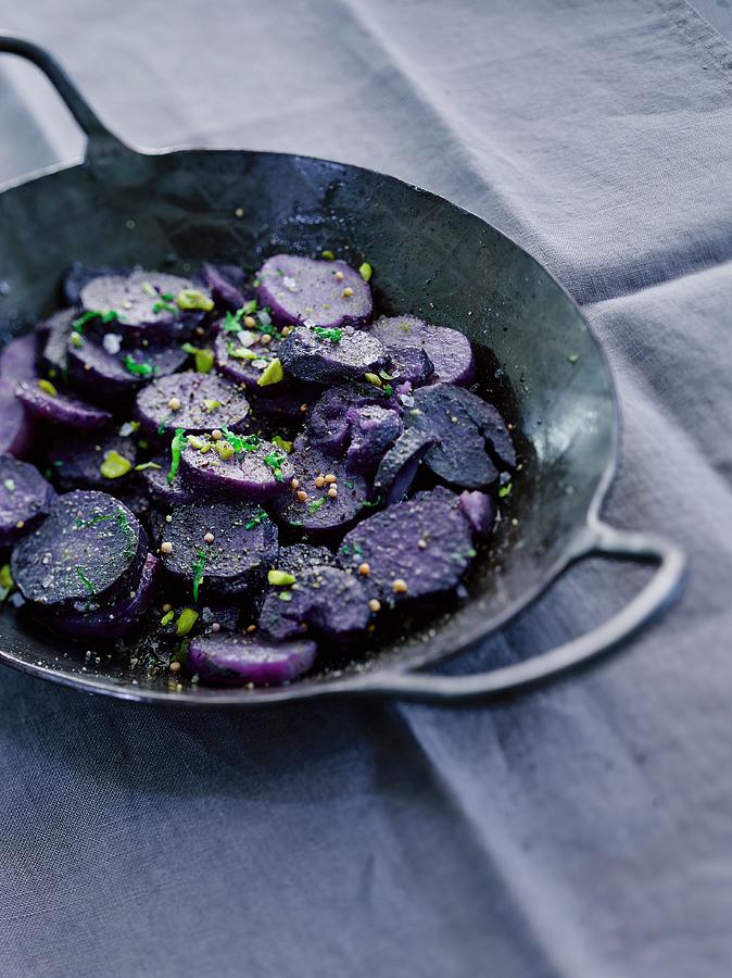 Vitelotte Potatoes In A Frying Pan Photograph by Michael Ruder