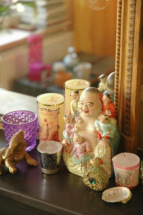 Votive Candles Around Buddha Figurine In Front Of Gilt-framed Mirror On Surface Photograph by James Stokes