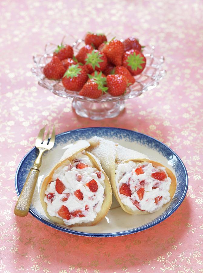 Wafer Cones Filled With Cream And Strawberries With Icing Sugar Photograph by Nicolas Leser