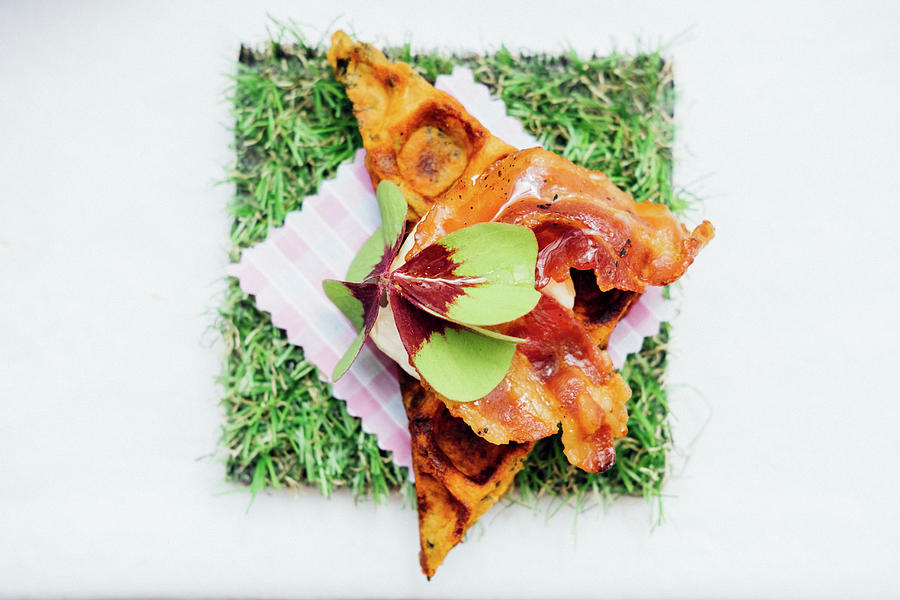 Waffle With Crispy Bacon, Maple Syrup And A Garnish Of Oxalis Leaf a Type Of Sorrel Photograph by Joan Ransley