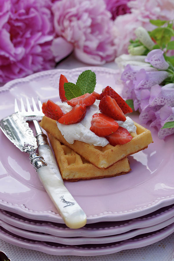 Waffles With Strawberries, Cream And Mint Leaves Photograph by Angelica Linnhoff