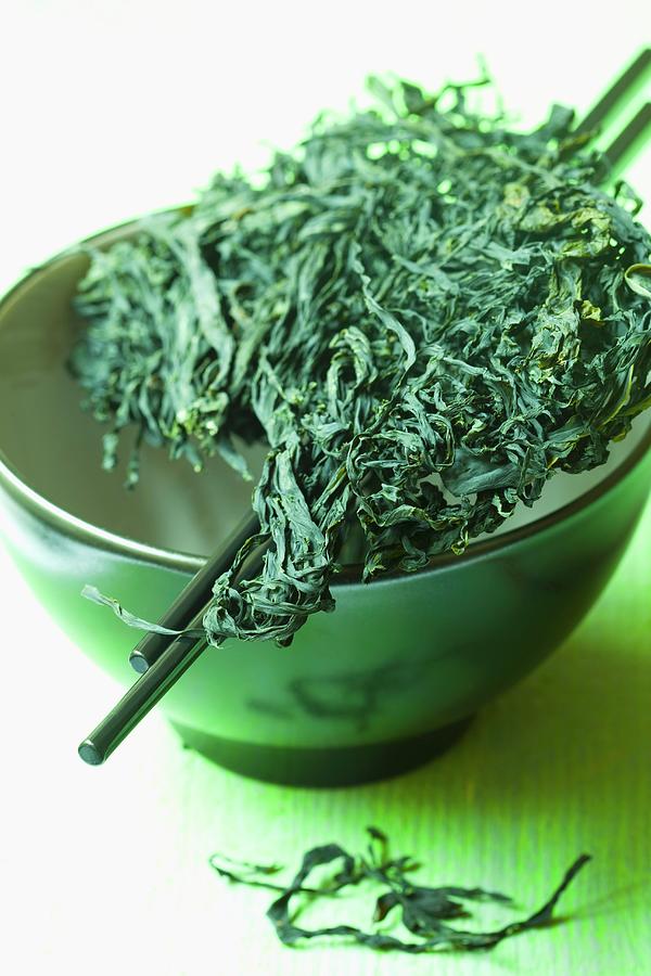 Wakame In A Ceramic Bowl With Chopsticks Photograph by Hilde Mche