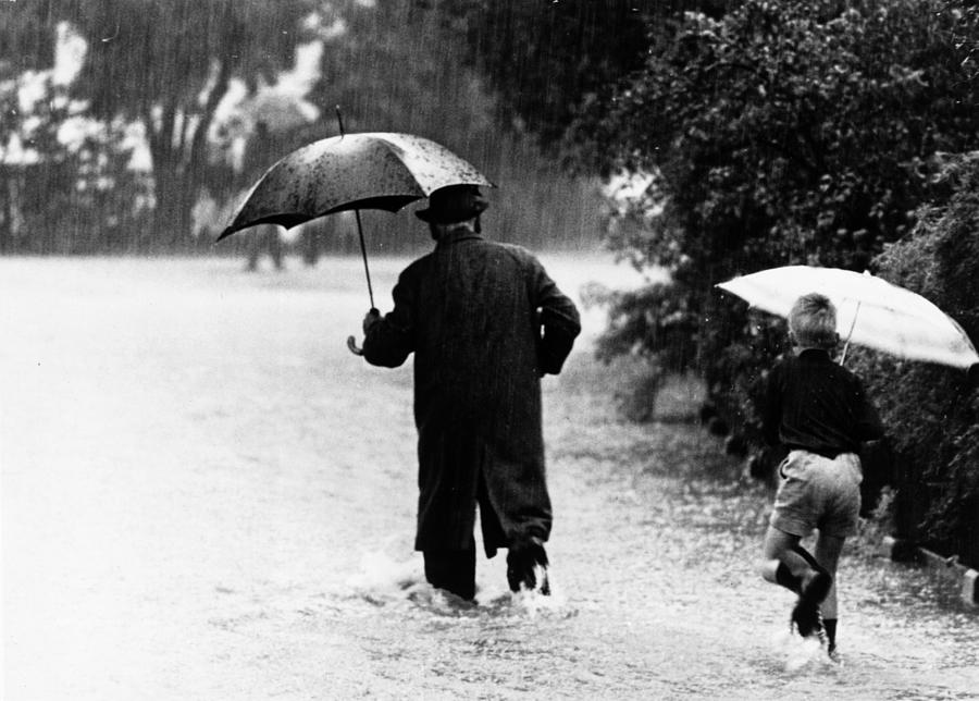 Walking In The Rain Photograph by Keystone