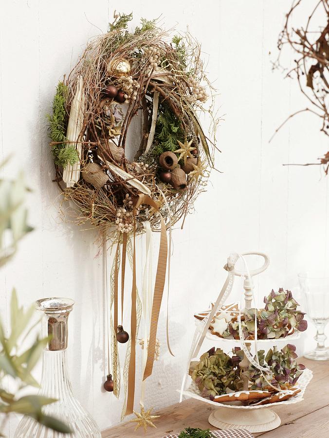 Wall Wreath Of Twigs, Dried Fruit And Christmas Tree Ornaments Photograph by Friedrich Strauss