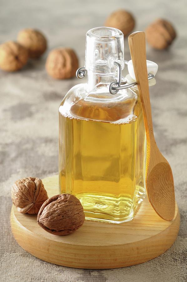 Walnut Oil And Walnuts Photograph by Jean-christophe Riou
