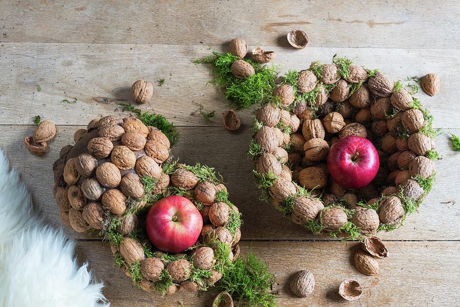 Walnuts And Apples In Baskets Made From Threaded Walnuts christmas Arrangement Photograph by Veronika Studer