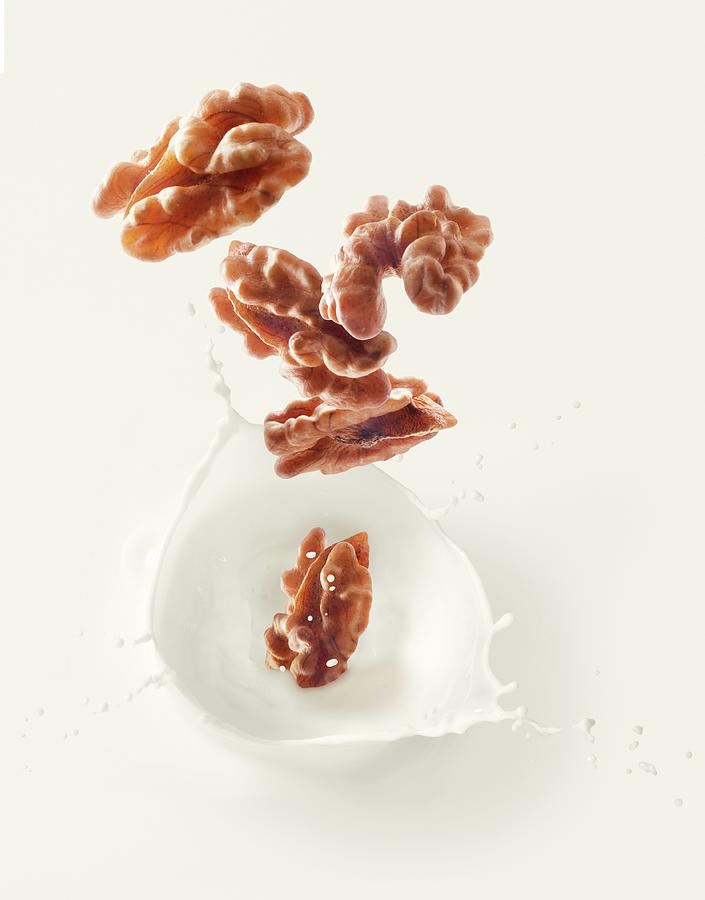 Walnuts Falling Into Walnut Milk Photograph by Krger & Gross