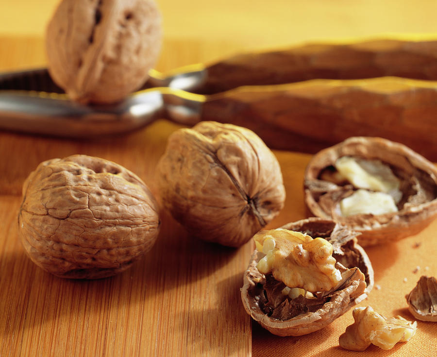 Walnuts juglans Regia, Whole And Opened, With A Nutcracker Photograph by Teubner Foodfoto