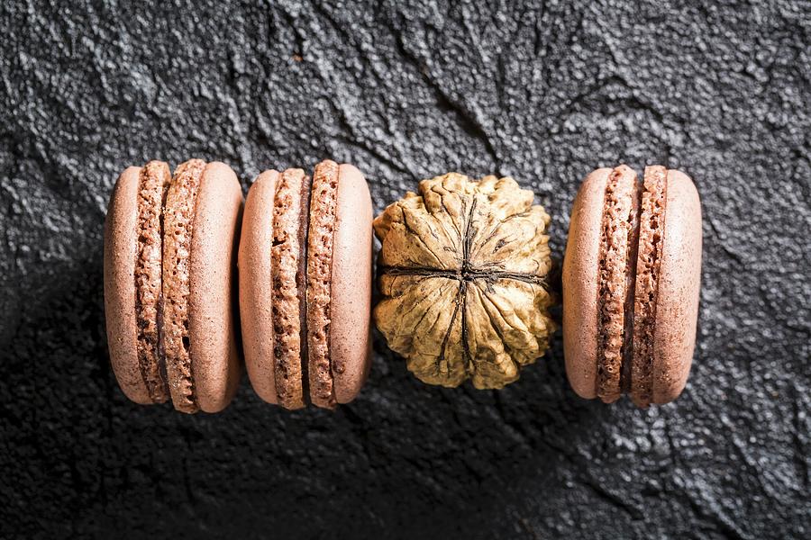 Walnuts Macaroons On A Black Stone Photograph by Shaiith