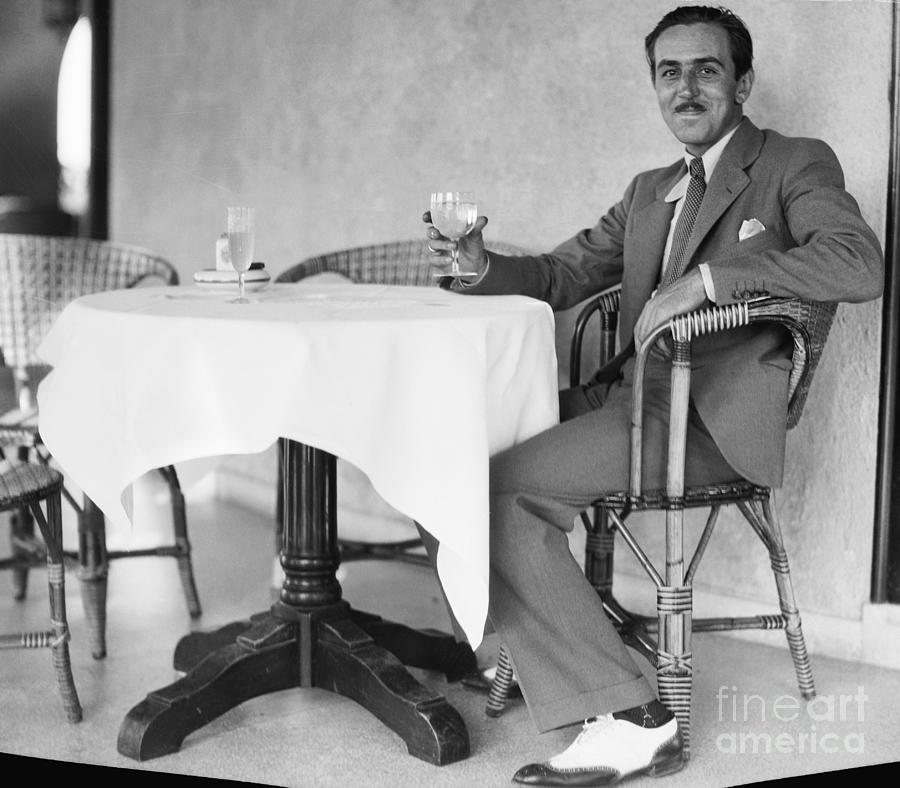 Walt Disney Sitting At Table Photograph by Bettmann