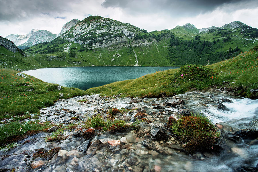 Water cascade into lake Formarinsee in Austria Photograph by Philip Steyrer