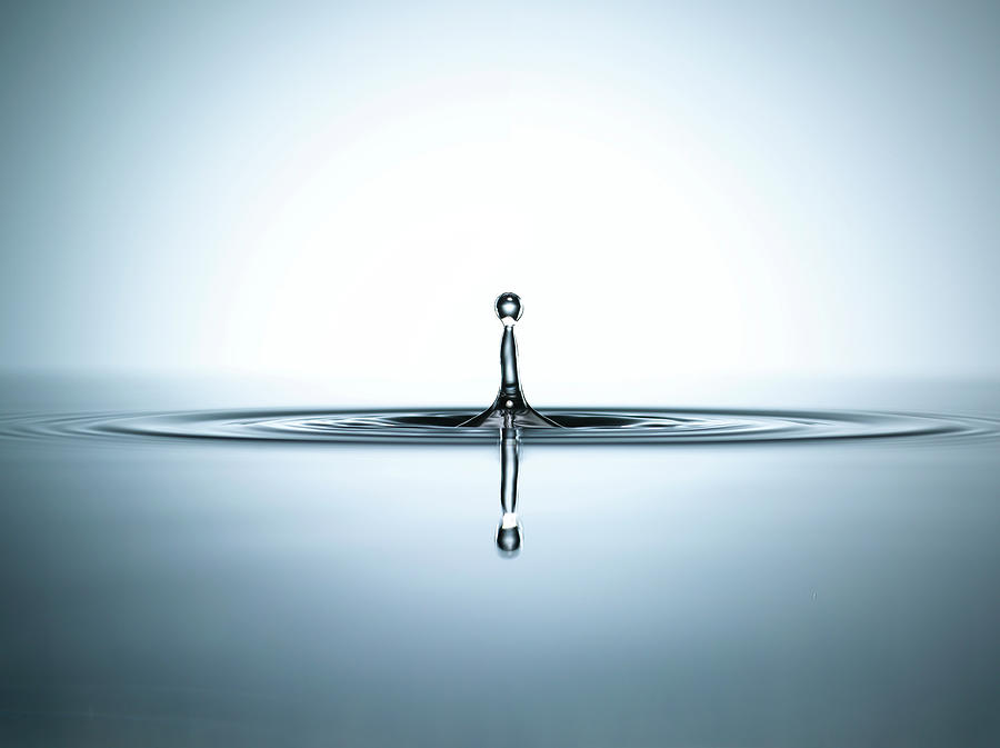 Water Droplet In A Pool Of Water Photograph by Chris Stein
