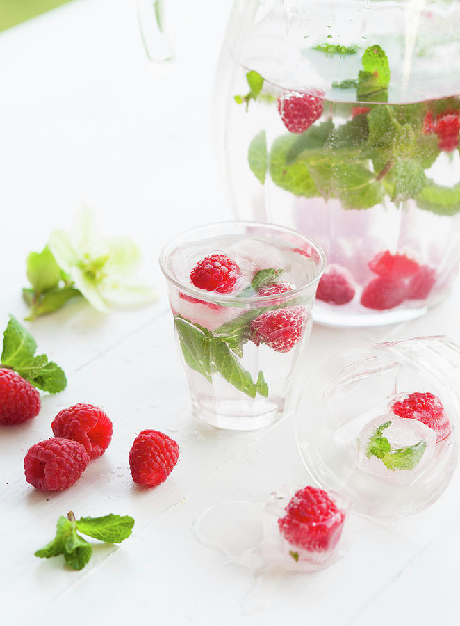 Water Flavoured With Raspberries, Mint And Ice Cube Photograph by Yasmijn Tan