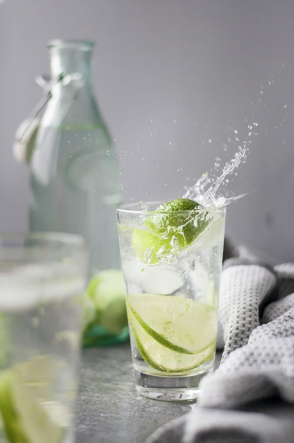 Water With Lime And Ice Cubes Photograph by Healthylauracom