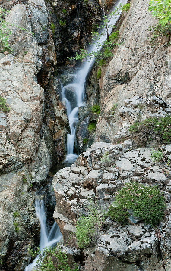 Waterfall, between a rocky mountain. Photograph by Michalakis Ppalis