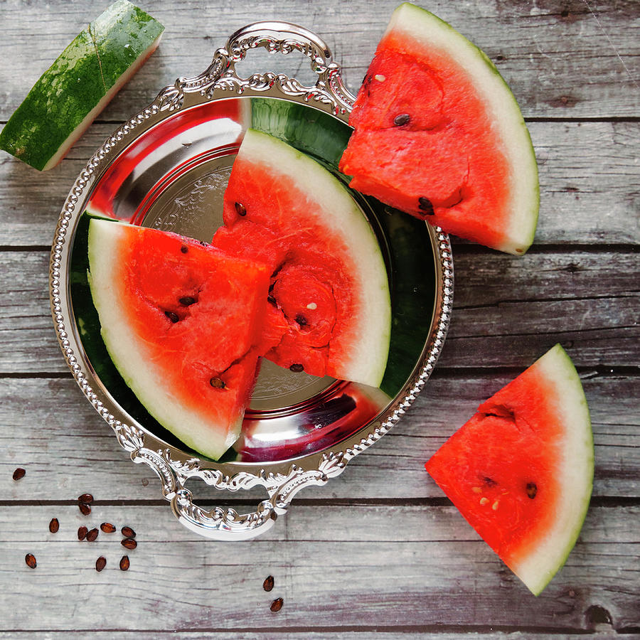 Watermelon Slices On A Silver Tray And A Wooden Background Photograph by Kuzmin5d