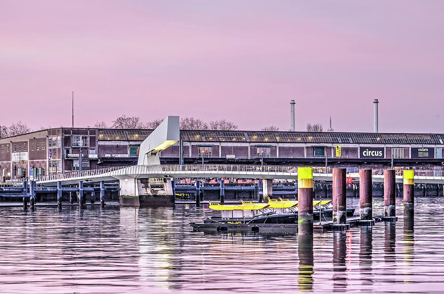 Watertaxis, bridge and warehouse at sunrise Photograph by Frans Blok