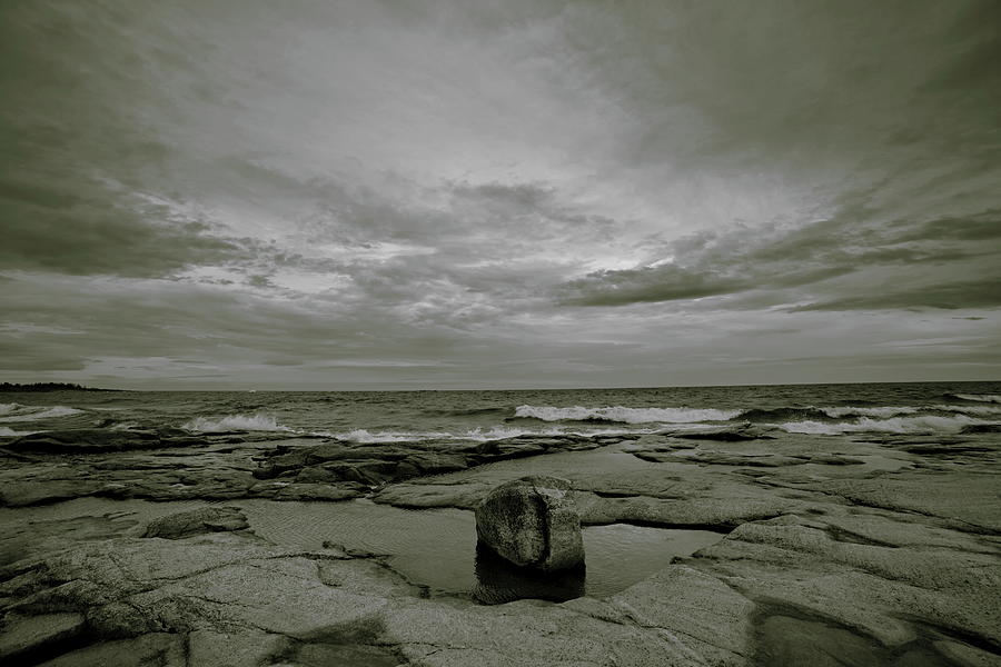 Waves Are Rolling Towards The Rocky Ocean Shore On A Windy Day - Sepia Photograph