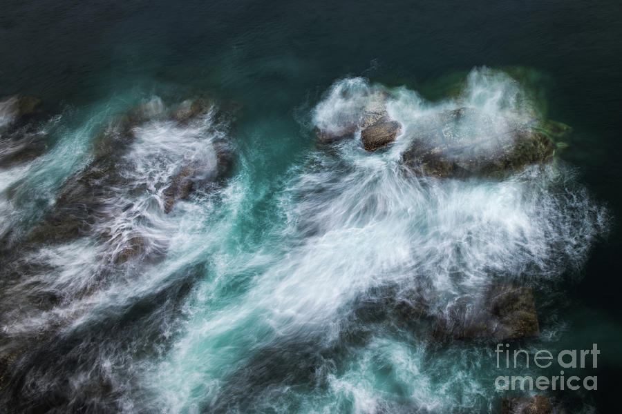 Waves Crashing Against Rocks On The Photograph by Between Life