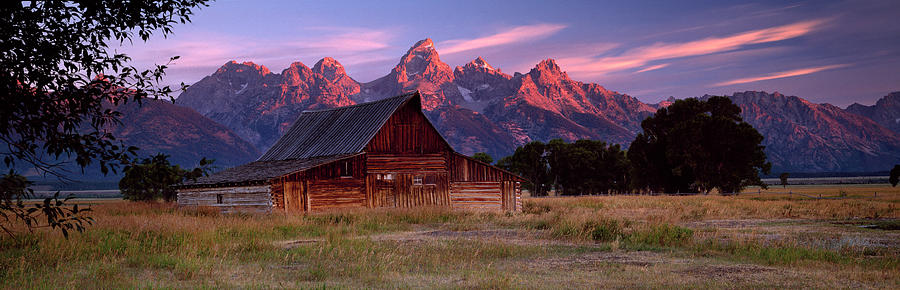 Grand Teton National Park Photograph - Weathered Wooden Barn With Mountains by Travelpix Ltd